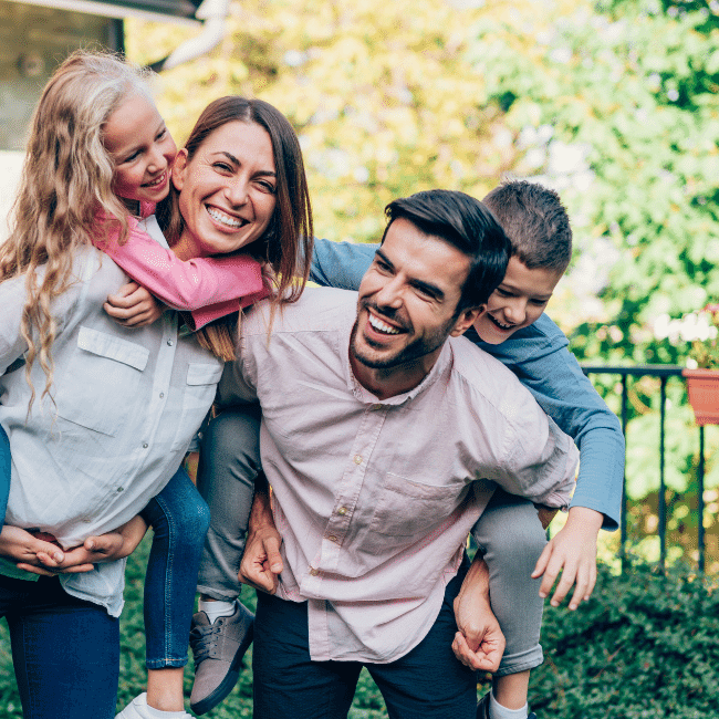 family in the yard who now understand the cost of buying a home in nsw