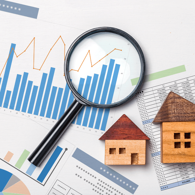 selling-your-house - 5 ways to emotionally prepare. Image shows a graph, magnifying glass and two wooden houses