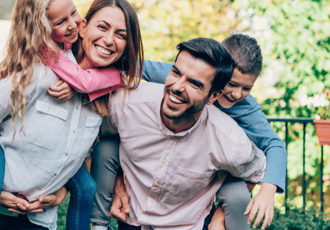 family in the yard who now understand the cost of buying a home in nsw