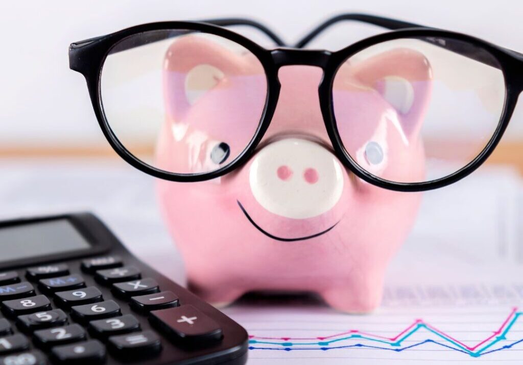 Get Your Affairs in Order - an image of a pink piggie bank with black glasses next to a black calculator